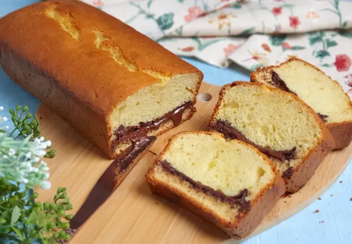 Plumcake soffice con cuore di cioccolato, perfetto per la tua ricetta. Fette golose su tagliere di legno.