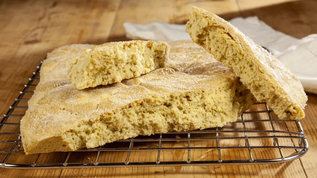 Focaccia dorata e friabile, cosparsa di zucchero, preparata con bicarbonato al posto del lievito. Perfetta per una colazione rustica.